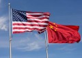 Symbolic of Sino-American relations, the flag of the United States of America and the flag of the Republic of China fly together on flag poles next to each other on a sunny, windy day.