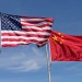 Symbolic of Sino-American relations, the flag of the United States of America and the flag of the Republic of China fly together on flag poles next to each other on a sunny, windy day.
