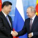 (FILES) In this file photo taken on September 11, 2018, Russia's President Vladimir Putin (R) shakes hands with his Chinese counterpart Xi Jinping during a signing ceremony following the Russian-Chinese talks on the sidelines of the Eastern Economic Forum in Vladivostok. - Chinese President Xi Jinping begins a state visit to Russia on March 20, 2023, a trip Beijing has touted as a "visit for peace" as it seeks to play mediator in Vladimir Putin's war in Ukraine. (Photo by SERGEI CHIRIKOV / POOL / AFP)
