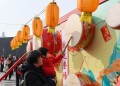 (240213) -- BEIJING, Feb. 13, 2024 (Xinhua) -- A child plays a drum during a Spring Festival event at the Shougang Park in Beijing, capital of China, Feb. 13, 2024. People across the country celebrated the Spring Festival through various events. (Xinhua/Ju Huanzong)