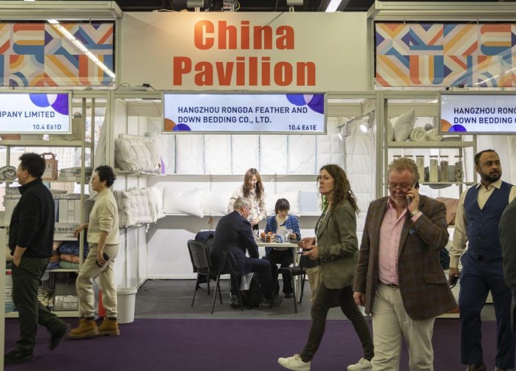 (240110) --FRANKFURT, Jan. 10, 2024 (Xinhua) -- Visitors walk past the China pavilion at the Heimtextil 2024 in Frankfurt, Germany, Jan. 9, 2024. Heimtextil 2024, an international platform for home and contract textiles and textile design, kicked off Tuesday in Frankfurt. (Xinhua/Zhang Fan)