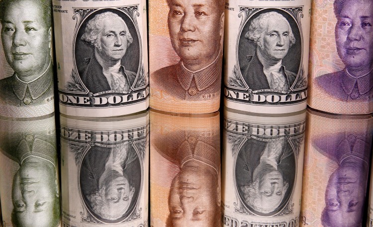 FILE PHOTO: Chinese Yuan and U.S. dollar banknotes are seen in this illustration taken February 10, 2020. REUTERS/Dado Ruvic/Illustration/File Photo