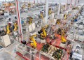 (240318) -- BEIJING, March 18, 2024 (Xinhua) -- An aerial drone photo taken on Jan. 8, 2024 shows robotic arms processing components for new energy vehicles at a private company in Changxing Economic and Technological Development Zone of Huzhou City, east China's Zhejiang Province. (Photo by Tan Yunfeng/Xinhua)