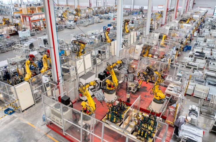 (240318) -- BEIJING, March 18, 2024 (Xinhua) -- An aerial drone photo taken on Jan. 8, 2024 shows robotic arms processing components for new energy vehicles at a private company in Changxing Economic and Technological Development Zone of Huzhou City, east China's Zhejiang Province. (Photo by Tan Yunfeng/Xinhua)