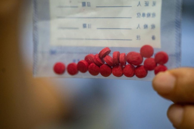 (230716) -- MANGSHI, July 16, 2023 (Xinhua) -- Yin Mingyan shows samples of crystal meth in Mangshi City, southwest China's Yunnan Province, July 13, 2023. Yin Mingyan is the deputy head of a law-enforcing team under a border management bureau in Dehong Dai and Jingpo Autonomous Prefecture, southwest China's Yunnan Province.
Back in 1997 when she was still in high school, she lost her brother Yin Mingzhi, a counter-narcotics officer who was seriously wouded and killed while arresting drug traffickers.
She joined the military upon graduation in 1998, and soon decided to fit in her brother's shoes and became a counter-narcotics officer.
She has been involved in more than 100 drug-related cases since then, resulting in the arrest of at least 230 suspects and the seizure of over 400 kilograms of drugs. (Xinhua/Hu Chao)